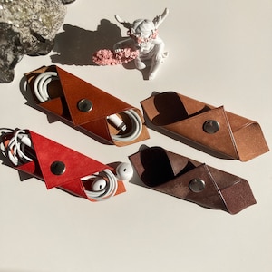 Auricolari organizzatore di cavi Avvolgitore a scatto Avvolgitore a scatto Custodia per cuffie in pelle Rack per cavi in pelle Accessori in pelle Organizzatore di cavi USB