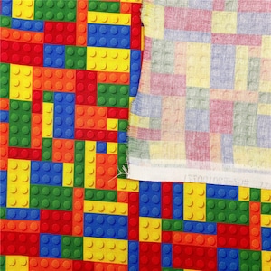 K&ouml;nnte beinhalten: Ein farbenfroher Stoff mit einem sich wiederholenden Muster aus roten, gelben, blauen und gr&uuml;nen Bausteinen. Der Stoff wird neben einem zweiten Stoff mit einem karierten Muster in Rosat&ouml;nen, Gelb und Blau gezeigt.