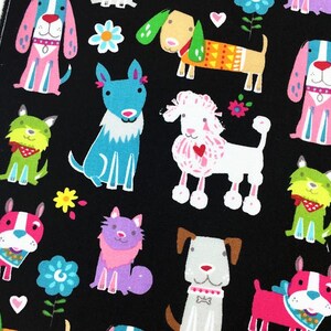 May include: Black fabric featuring a repeating pattern of colorful cartoon dogs, cats, and flowers. The dogs are depicted in various poses and colors, including pink, blue, green, and white. The cats are purple. The flowers are yellow and blue.