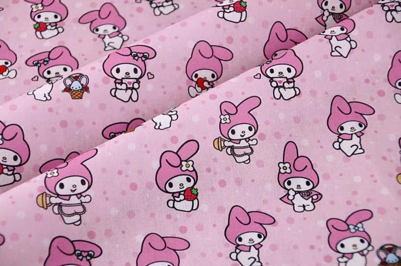 May include: Pink fabric with a repeating pattern of a cartoon rabbit wearing a pink dress and a bow. The background is a light pink with white polka dots.