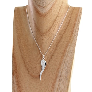 May include: A silver necklace featuring a single wing pendant. The wing is detailed with small, sparkling stones.