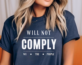 May include: A navy blue t-shirt with the text "WILL NOT COMPLY WE THE PEOPLE" printed in white.