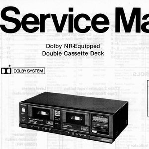 May include: A black and silver cassette deck with the text "Dolby NR-Equipped Double Cassette Deck" and "RS-T10" printed on the front. The deck has two cassette slots and a variety of buttons and knobs. The text "Color (K)...Black Type (S)...Silver Type" is printed below the deck.