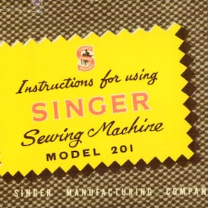 May include: Yellow instruction booklet with a black and white Singer Sewing Machine logo. The text reads "Instructions for using SINGER Sewing Machine MODEL 201". The booklet is on a brown patterned background.