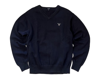 Maglione Gant con scollo a V in cotone, blu navy, stile minimalista.