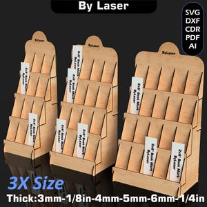 May include: Three wooden display stands with multiple shelves, each holding several white rectangular cards labeled "2x6 Book Mark ByLaser." The stands are labeled "By Laser" and "3X Size." The thickness is 1/8in to 1/4in.