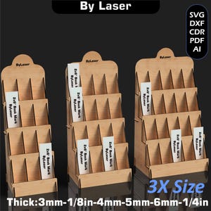 Puede incluir: Tres expositores de madera con m&uacute;ltiples estantes, cada uno con varias tarjetas blancas con la etiqueta "2x6 Book Mark ByLaser". Los expositores est&aacute;n etiquetados "By Laser" y "3X Size". El grosor de la madera es de 3mm-6mm.