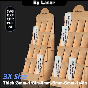 Puede incluir: Expositores de madera con m&uacute;ltiples estantes, etiquetados "By Laser" en la parte superior. Cada expositor contiene varios marcadores rectangulares blancos que dicen "2x6" Book Mark ByLaser." La imagen tambi&eacute;n incluye texto que indica formatos de archivo y grosores.