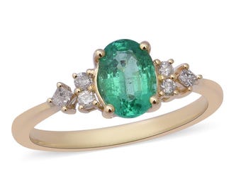 May include: A gold ring with a green oval emerald gemstone and smaller diamond accents.