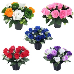 May include: Five artificial rose arrangements in black pots. The roses are in various colours: orange, white, green, pink, red, blue, and purple. Each arrangement includes green leaves and small white flowers.