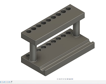 May include: A gray, rectangular tool holder featuring two levels with eight circular openings on the top tier and eight corresponding circular indentations on the base. The structure is supported by two cylindrical pillars, and the base includes a long groove.