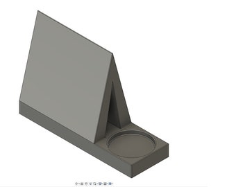 May include: A gray, three-dimensional computer-aided design model of a triangular, tent-shaped structure attached to a rectangular base. The base features a circular, recessed indentation on one side, positioned next to the angled, upright wall.