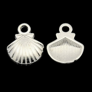 May include: Two silver-toned metal charms shaped like seashells. The charms have a textured surface and a loop at the top for attaching to jewellery.