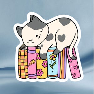 Cozy Cat on Colorful Books Sticker – Cute Cat Bookish Sticker for Readers & Bookworms, Laptops, Water Bottles, Journals, Kindles