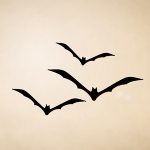 May include: Four black bat silhouettes in flight against a cream-colored background. The bats are depicted with outstretched wings, creating a dynamic and spooky Halloween theme.
