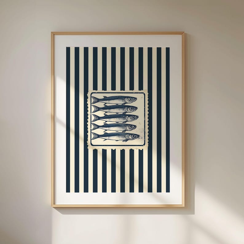 May include: Framed art print featuring a vintage-style illustration of five fish. The fish are in a rectangular stamp design, set against a background of navy blue and cream vertical stripes. The frame is a light wood color.