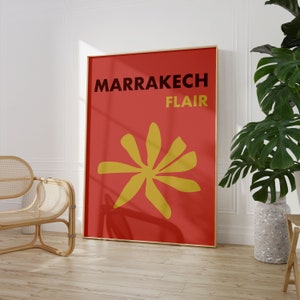 May include: A red poster with the text "MARRAKECH FLAIR" in black and a yellow stylized flower design.
