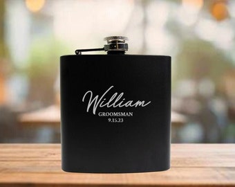 May include: Black metal flask with a silver cap and engraved text that reads "William, Groomsman 9.15.23".
