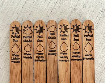 May include: Set of eight wooden plant markers with different sun and watering requirements. The markers feature icons for full sun, partial sun, full shade, partial shade, and water requirements ranging from lightly weekly to bi-weekly.