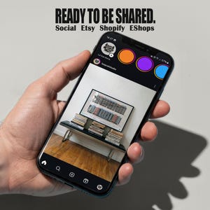 May include: A smartphone displays an Instagram-like interface with a photo of a room with books and a framed artwork. The phone screen shows the text "READY TO BE SHARED. Social Etsy Shopify EShops."