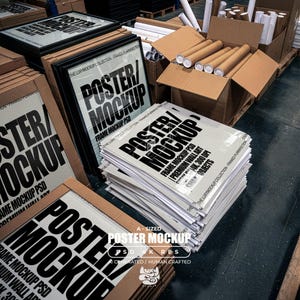 May include: A stack of rectangular posters featuring the bold black text POSTER/MOCKUP, FRAME MOCKUP PSD, PREMIUM WALL ART, 300 DPI, and SMART OBJECTS. The posters are displayed in black frames and loose sheets within a warehouse environment.