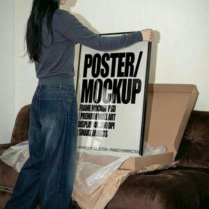 Frame Mockup PSD  – Premium Wall Art Display | 4K, 300 DPI, Smart Objects, Unboxing Poster Mockup with person. Framed Poster Video Mockup • Unboxing Frame on Iconic 70s  Sofa • Realistic Wall Art Presentation • Minimal Interior Lifestyle Mockup • PSD Mockup