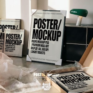 May include: A white framed poster mockup with the words "POSTER/MOCKUP" in large black text. The image shows several mockups, with the text "FRAME MOCKUP PSD", "PREMIUM WALL ART DISPLAY 4K, 300 DPI" and "SMART OBJECTS". The scene includes packaging and a green desk lamp.