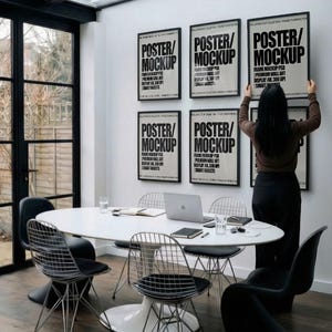 6 A-size frames gallery wall video mockup PSD. A woman hangs black poster mockups in a modern dining room. Premium wall art display for social media.