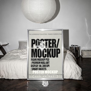 May include: A vertical rectangular silver frame containing a poster with bold black text that reads POSTER/MOCKUP, THE LUXYMOCKUP COLLECTION - FRAMED PURRRFECTION, FRAME MOCKUP PSD, PREMIUM WALL ART DISPLAY 4K, 300 DPI, SMART OBJECTS, and PSD 4K RES.