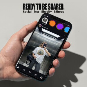 Oversized white t-shirt mockup featuring a trendy woman taking a mirror selfie in an elevator, ideal for streetwear brands. tshirt mock up for e-commerce and social media posts.