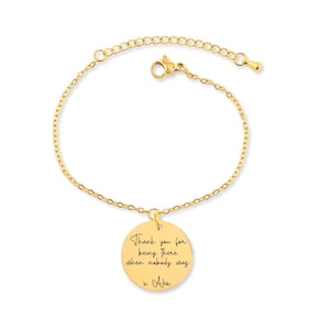 May include: Gold chain bracelet with a round charm that says "Thank you for being there when nobody was x Alex".
