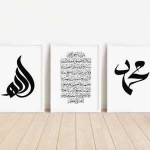 Puede incluir: Tres impresiones enmarcadas en blanco y negro con caligrafía islámica. La impresión de la izquierda presenta la palabra "Allah" en escritura árabe. La impresión del centro presenta un largo pasaje de texto árabe vertical. La impresión de la derecha presenta la palabra "Muhammad" en escritura árabe.