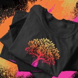 May include: A black t-shirt with a colorful tree design. The tree is a gradient of yellow, orange, and red. The shirt is folded and displayed on a colorful background.