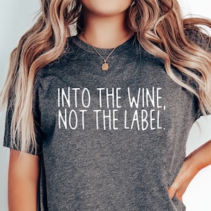 May include: A dark gray t-shirt with the text "Into the wine, not the label." printed in white.