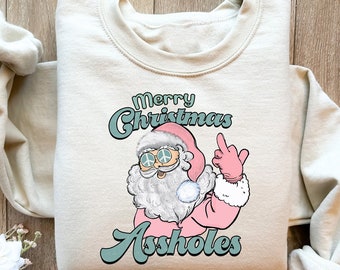メリークリスマス アスホールズ 面白いサンタシャツ、面白いサンタスウェットシャツ、ホリデーシーズンパーカー、クリスマスサンタTシャツ、ピンクサンタシャツ、クリスマスギフト