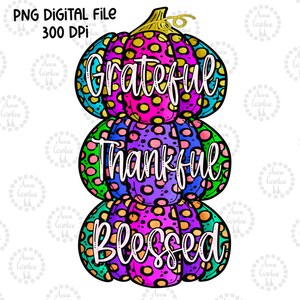 May include: A stack of three colourful pumpkins with polka dots and a watercolour effect. The pumpkins are decorated with the words "Grateful", "Thankful", and "Blessed".