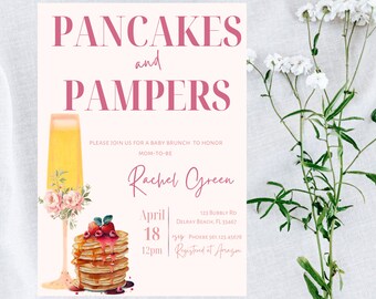 May include: A pink and white baby shower invitation with the text "Pancakes and Pampers" and a graphic of a glass of mimosa and a stack of pancakes. The invitation includes the date, time, and location of the event, as well as the name of the mom-to-be, Rachel Green.