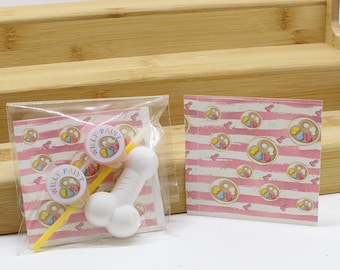 May include: Two small containers of paint with the words "Willy Paint" on them, a yellow paintbrush, and a white plastic bone-shaped object. The items are packaged in a clear plastic bag with a pink and white striped background.
