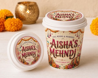 May include: A white paper cup and a separate white lid, both featuring a colorful decorative label with the text "Chai, Mehndi & Memories, Aisha's Mehndi, 12th September 2026" surrounded by floral patterns, marigold garlands, and paisley motifs.