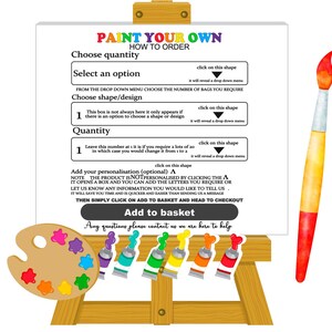 May include: A white easel with a sign that says "Paint Your Own, How To Order". The sign has instructions for choosing a quantity, selecting an option, choosing a shape or design, and adding personalization. There is a paintbrush and a palette of paint colors.