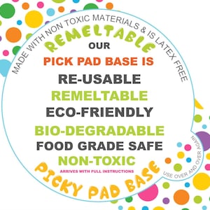 May include: A colourful circular sticker with the text "REMELTABLE OUR PICK PAD BASE IS RE-USABLE REMELTABLE ECO-FRIENDLY BIO-DEGRADABLE FOOD GRADE SAFE NON-TOXIC ARRIVES WITH FULL INSTRUCTIONS USE OVER AND OVER AGAIN PICKY PAD BASE". The sticker is surrounded by a ring of colourful dots.