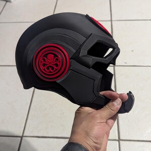 May include: A black helmet with a red Hydra logo on the side. The helmet has a visor and a chin guard.