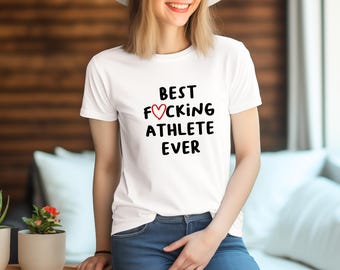 May include: White t-shirt with black text that reads "Best F♡cking Athlete Ever".
