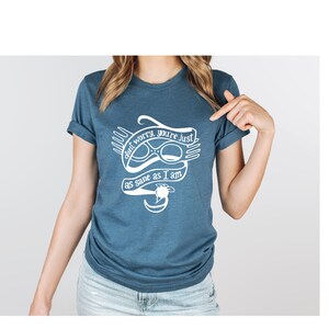 May include: A blue t-shirt with a white graphic of a pair of glasses and the text "don't worry, you're just as sane as I am".