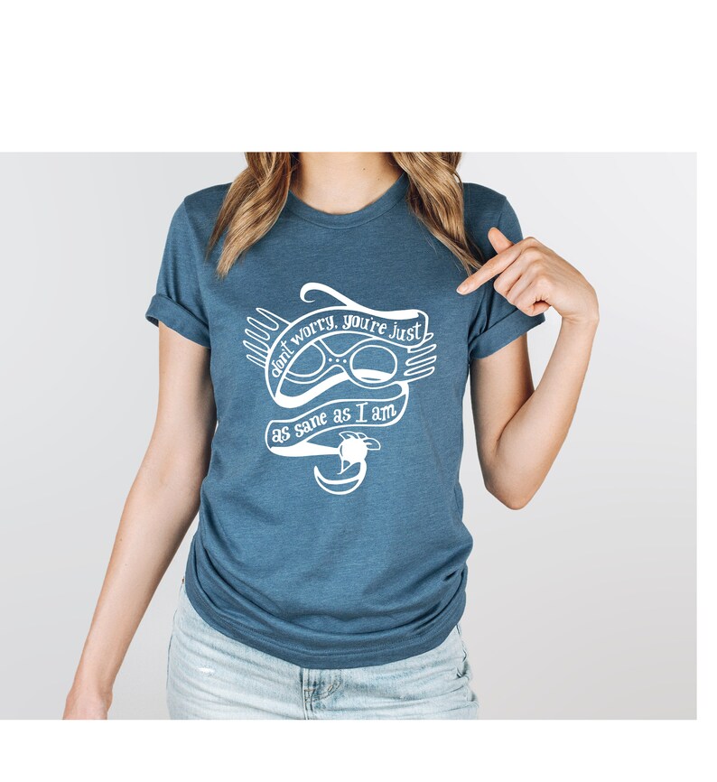 May include: A blue t-shirt with a white graphic of a pair of glasses and the text "don't worry, you're just as sane as I am".