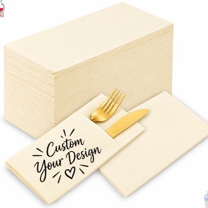 May include: A large stack of folded cream-coloured paper napkins with a pocket design. One napkin features the black printed text Custom Your Design with a heart icon, holding a gold-toned metal fork and a gold-toned metal knife inside the pocket.