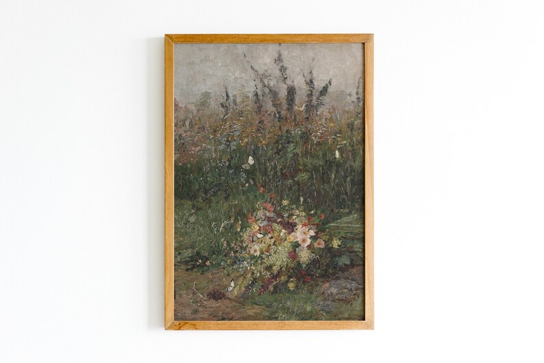 Pode incluir: Uma pintura emoldurada que retrata um buqu&ecirc; de flores silvestres em um campo. As flores s&atilde;o uma mistura de rosa, branco e amarelo, e o campo &eacute; de um verde e marrom opacos. A pintura est&aacute; sobre um fundo branco.