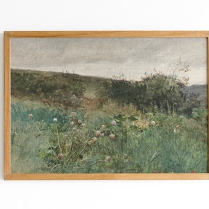 May include: A framed landscape painting featuring a field of tall green grass and wildflowers under a cloudy sky. The artwork has a vintage aesthetic, with a wooden frame and muted color palette.