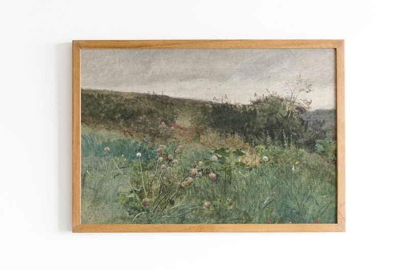 May include: A framed landscape painting featuring a field of tall green grass and wildflowers under a cloudy sky. The artwork has a vintage aesthetic, with a wooden frame and muted color palette.