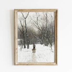May include: A framed painting depicting a snowy forest scene with a person pulling a sled. The trees are bare and the ground is covered in snow. The person is wearing a dark coat and hat.